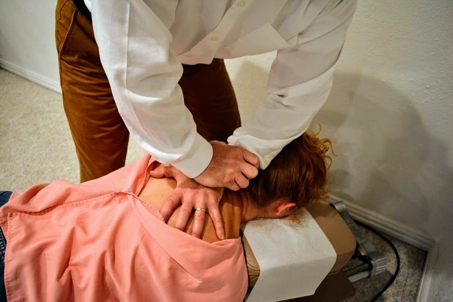 Patient receiving Chiropractic care to relieve pain in the upper back.